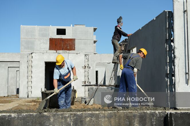 Строители осуществляют монтаж стеновых панелей цокольного этажа многоквартирного жилого дома компании "Дискус плюс" в Новосибирске. Место: Россия, Новосибирск. Автор: Александр Кряжев/РИА Новости. Строительство нового микрорайона "Просторный" в Новосибирске