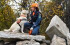 Кинолог с собакой во время учений, посвященных 89-й годовщине образования гражданской обороны, на учебной площадке центра по проведению спасательных операций особого риска "Лидер" МЧС России в Москве. День гражданской обороны ежегодно отмечается в России 4 октября. Место: Россия, Москва. Автор: Илья Питалев. ФОТО НЕДЕЛИ
